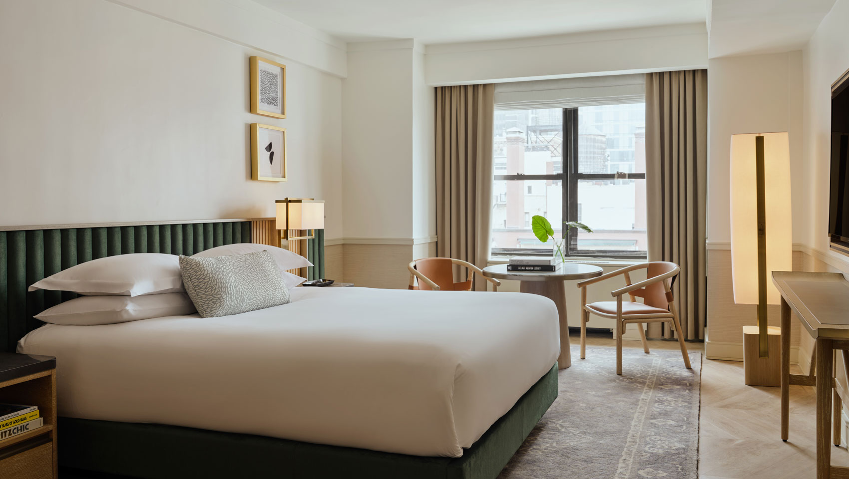 Guestroom with king bed and table with chairs at Kimpton Ashbel Hotel