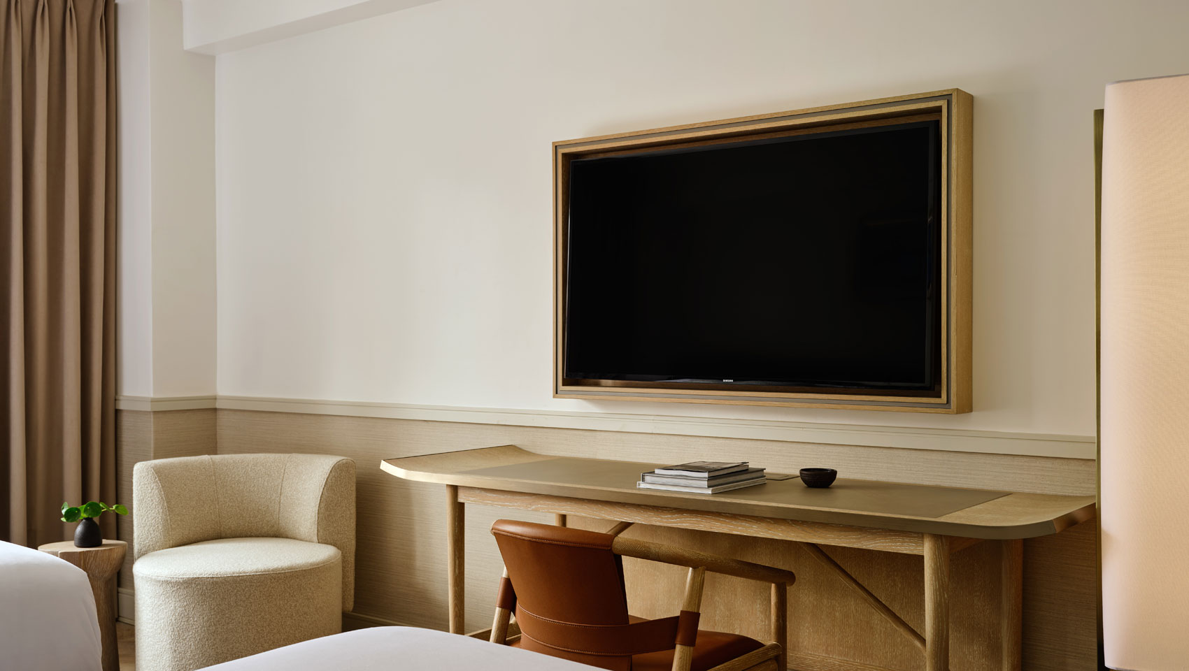 workspace, chair and TV in guestroom at Kimpton Ashbel Hotel