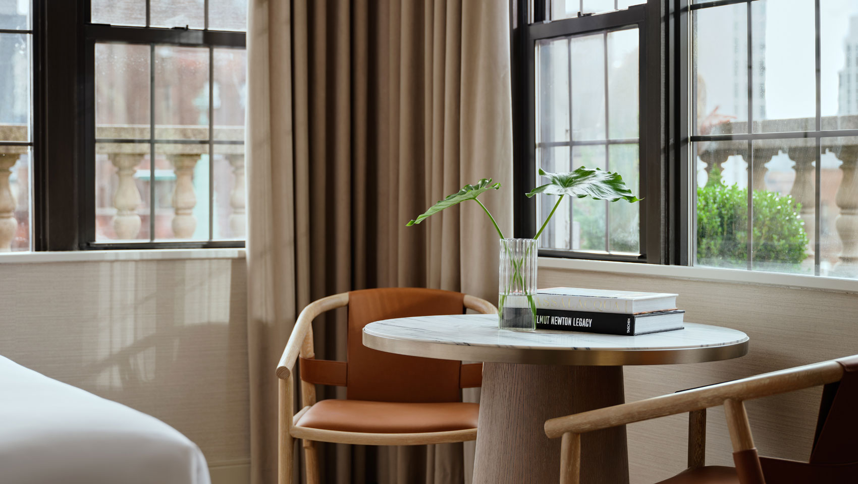 table with chairs and window views at Kimpton Ashbel Hotel