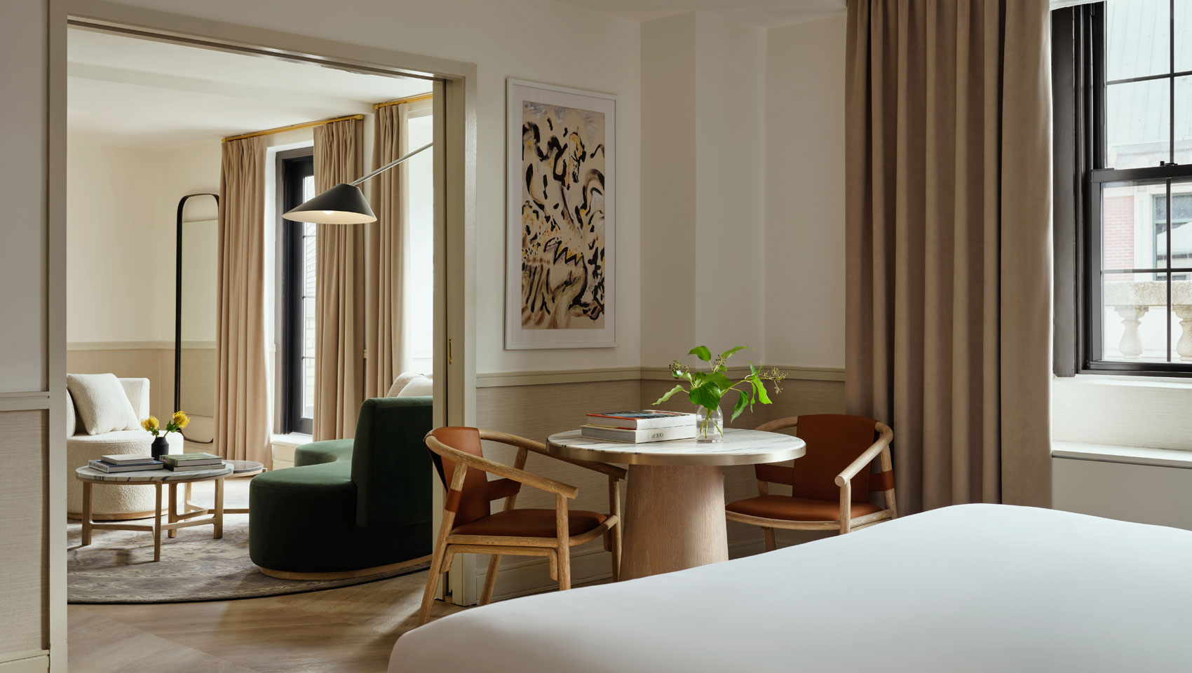 Suite bedroom with view of sitting area at Kimpton Ashbel Hotel